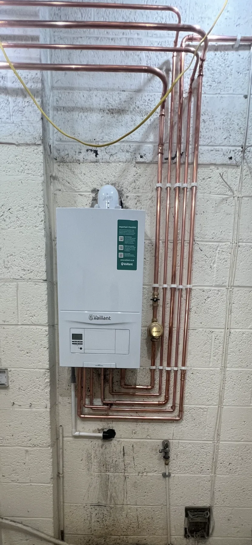 Completed boiler installation with tidy first fix pipework